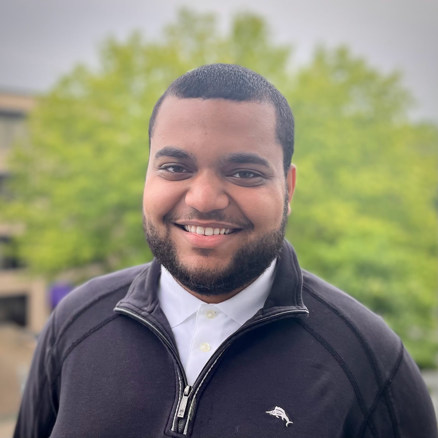 Portrait of Cesar Matos, founder of SGA Sync, smiling outdoors on campus